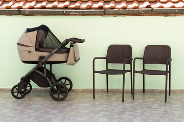 baby carriage with two empty chairs
