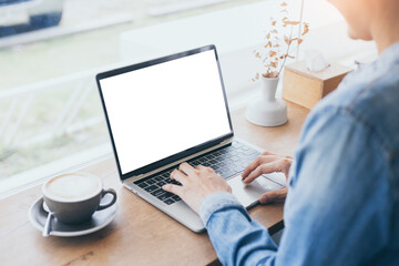Fototapeta premium computer mockup blank screen.hand woman work using laptop with white background for advertising,contact business search information on desk at coffee shop.marketing and creative design