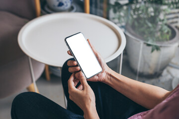 cell phone mockup blank white screen.woman hand holding texting using mobile on desk at coffee shop.background empty space for advertise.work people contact marketing business,technology