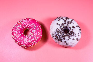 Fresh glazed donuts isolated on a pink background