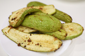 On plate are cooked zucchini with seasoning and garlic. Vegetarianism and diet as lifestyle concept