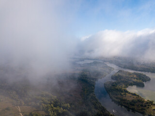 Flight among thick clouds over the Dnieper river in Kiev.
