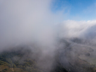 Flight among thick clouds over the Dnieper river in Kiev.