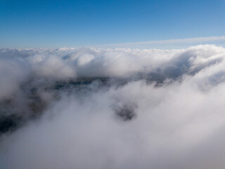Fototapeta na wymiar Flight among thick clouds over the Dnieper river in Kiev.