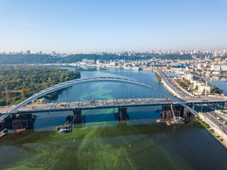 Aerial drone view. A cable-stayed bridge under construction across the Dnieper River in Kiev.