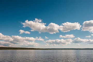 Vuoksa river near Imatra in the Leningrad region, Russia. Coastline with pine forest reflected in Vuoksa water, near Finland. River bank