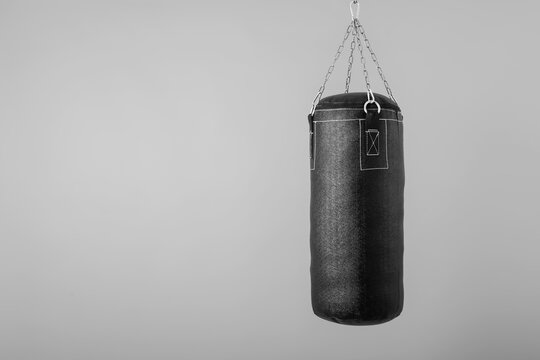 punching bag hanging on colorful background with blank space