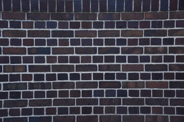 Vintage handmade dark red or black  brick cladding wall texture