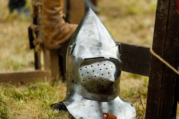 metal medieval helmet lies on the grass. for knightly duels