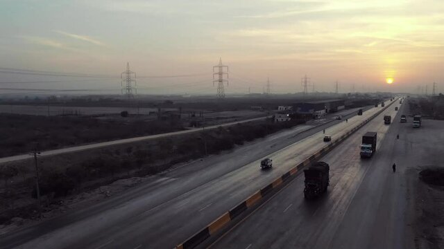 Aerial View Of Traffic Travelling On Karachi to Hyderabad Motorway During Sunset. Follow Shot