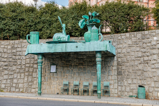 The Feast of Giants bus stop by wall against plants. Artist: David Cerny. Liberec, North Bohemia, Czech republic