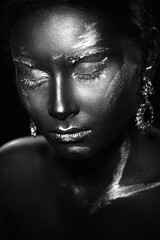 Portrait of a beautiful girl with an exquisite fantasy makeup in the style of legends about ancient greece and the pharaohs in black and white