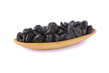 Dried prunes in wood dish isolated on white