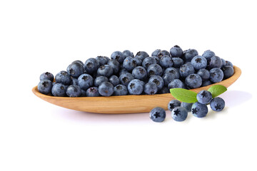 Blueberries in a wooden bowl with ltaves isolated on white