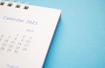 calendar page 2021 close up on blue background business planning appointment meeting concept