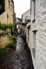 Fototapeta na wymiar River Pol surrounded with light-painted houses in Polperro, Cornwall, England, UK