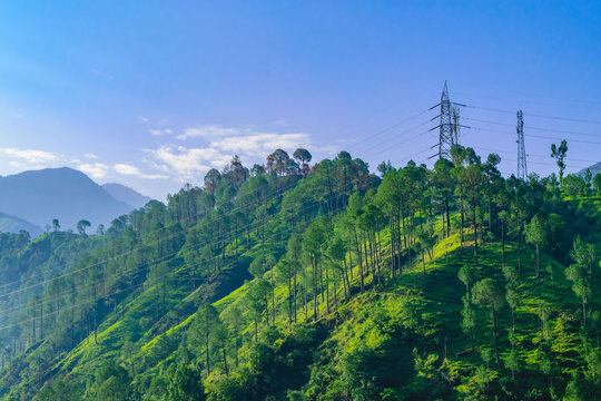 Transmission tower or pylon a steel lattice tower support overhead power line. Electricity transmission in mountain regions through complicated geographic conditions in Himachal Pradesh, India.