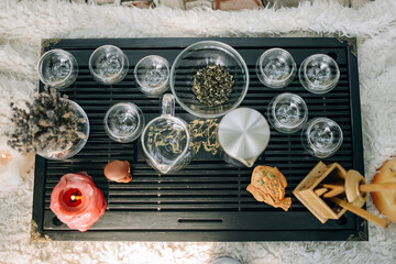 A table for the tea ceremony, on it there are glassware and candles for the atmosphere. Top view