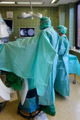 urologist performs a renal endoscopy with an X-ray machine in an operating room