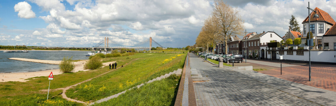 Panoramic view on the riverfront of Zaltbommel, Gelderland, with in the background the famous Martinus Nijhoff suspension bridge crossing the river Waal.
