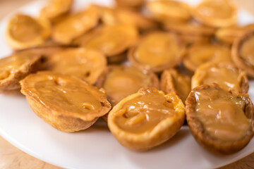 Filled with boiled condensed milk cookie halves Nut on a white plate close up, macro