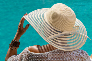 woman at spa resort by the swimming pool.