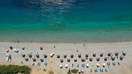 Aerial top down photo of famous organised crystal clear turquoise sandy beach of Panormos, Skopelos isalnd, Sporades, Greece