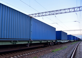 Cargo Containers Transportation On Freight Train By Railway. Intermodal Container On Train Car....