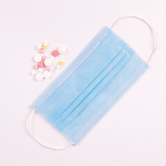 pills and mask on white background