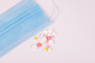 pills and mask on white background