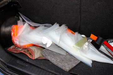 A mess of Different things in the trunk of a car.