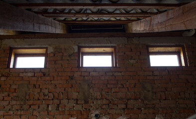 Fototapeta na wymiar the old brick wall with three windows