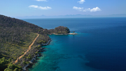Fototapeta premium Aerial drone photo of famous from Mamma Mia movie Three pine cape Amarantos a trully scenic place with crystal clear sea, Skopelos island, Sporades, Greece