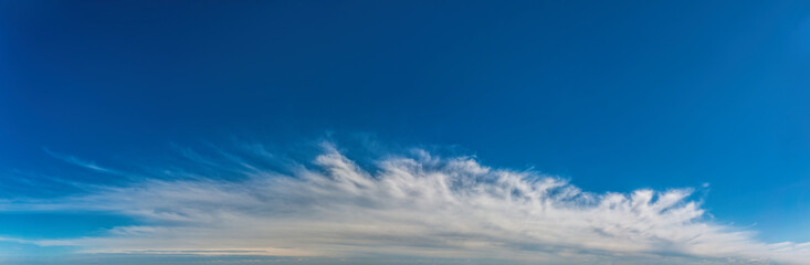 Fantastic clouds against blue sky, panorama