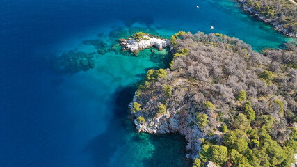 Fototapeta na wymiar Aerial drone photo of famous from Mamma Mia movie Three pine cape Amarantos a trully scenic place with crystal clear sea, Skopelos island, Sporades, Greece