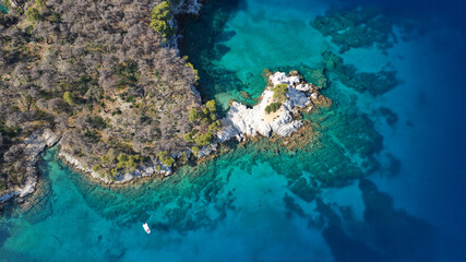 Naklejka na ściany i meble Aerial drone photo of famous from Mamma Mia movie Three pine cape Amarantos a trully scenic place with crystal clear sea, Skopelos island, Sporades, Greece