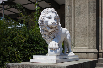 ALUPKA, CRIMEA - August 03, 2020: Marble statue of a lion with a paw on a ball