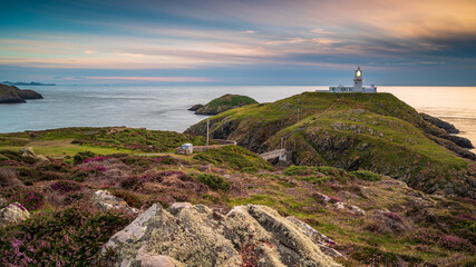 Fototapeta na wymiar Strumble Head Lighthouse, Pembrokeshire, at sunset