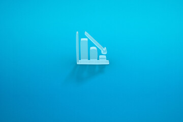 a falling graph in a blue background. a falling arrow. 3D rendering.