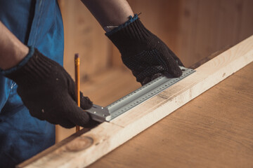 Man drawing line with pencil and holding raw as ruler.  House improving, DIY and home decoration