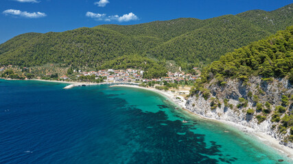 Aerial drone photo of small fishing village of Neo Klima with nearby popular beach of Hovolos, Skopelos island, Sporades, Greece