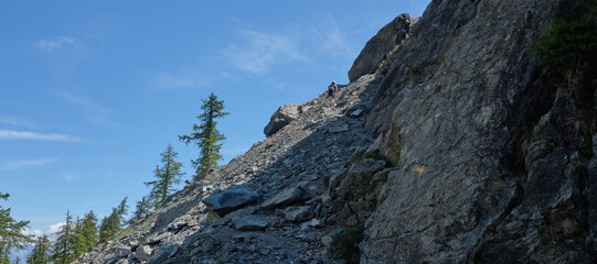 alone woman along path in mountain - girl hiking .