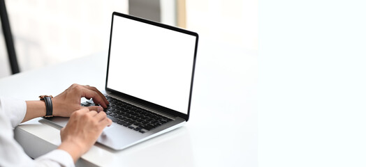 Copy space of man hand typing keyboard with office table background.