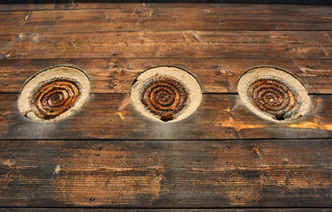 Beehouse with bee baskets behind wooden planks