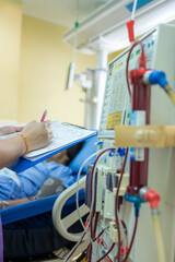 The specialist are checking continuous renal replacement therapy equipment and injection pump and...