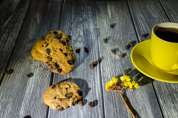 Still life with cup of coffee and chocolate cakes on the grey background