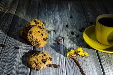 Still life with cup of coffee and chocolate cakes on the grey background