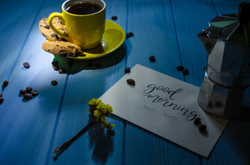 Still life with cup of coffee and chocolate cake on the blue background