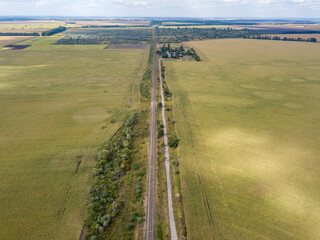 Aerial drone view. Railroad through agricultural fields.