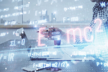 Science formula hologram with man working on computer on background. Education concept. Double...
